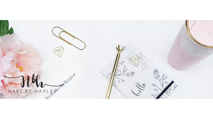 White desk Banner with pink and gold accessories.