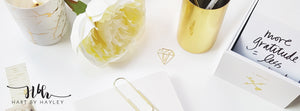 Relaxing white desk banner with gold accessories.