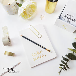 White desk set up with gold accessories stock photo